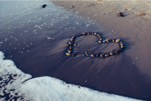 heart made of rocks in sand