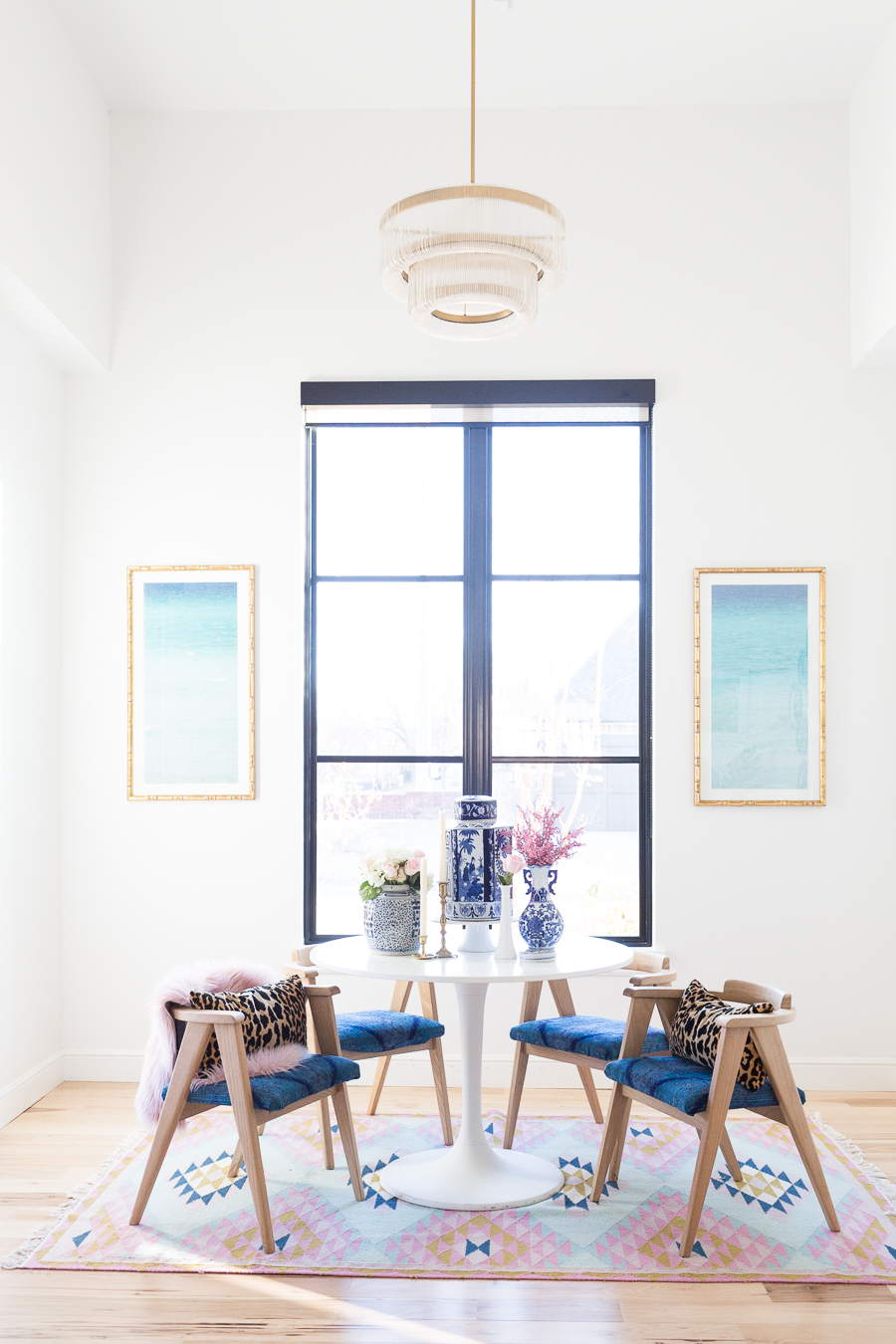 Rooms We Love Home Tour Navy and Pink Modern Glam Breakfast Nook Glittler Guide elodie rug blue and white tabletop vases gold candlesticks black windows wishbone chairs white round table colorful dining room rugs-3.jpg-1.jpg