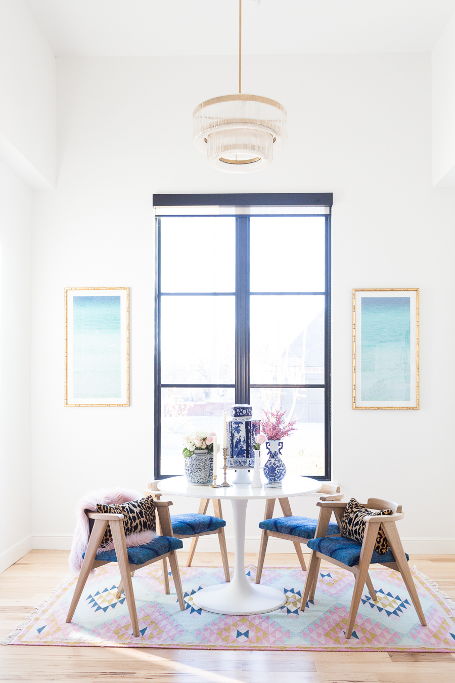 https://ccandmike.com/wp-content/uploads/2018/01/February-Rooms-We-Love-Home-Tour-Modern-Glam-Breakfast-Nook-wishbone-chairs-white-round-table-pink-fur-throw-leopard-pillows-rosemary-beach-art-gold-frame-blue-and-white-vases-5.jpg