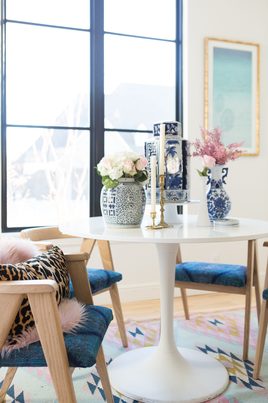 Rooms We Love Home Tour Navy and Pink Modern Glam Breakfast Nook Glittler Guide elodie rug blue and white tabletop vases gold candlesticks black windows wishbone chairs white round table colorful dining room rugs-3.jpg-1.jpg