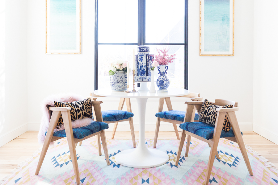 Rooms We Love Home Tour Navy and Pink Modern Glam Breakfast Nook Glittler Guide elodie rug blue and white tabletop vases gold candlesticks black windows wishbone chairs white round table colorful dining room rugs-3.jpg-1.jpg