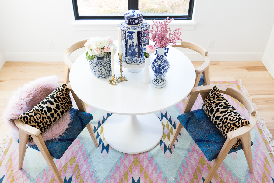 Rooms We Love Home Tour Navy and Pink Modern Glam Breakfast Nook Glittler Guide elodie rug blue and white tabletop vases gold candlesticks black windows wishbone chairs white round table colorful dining room rugs-3.jpg-1.jpg