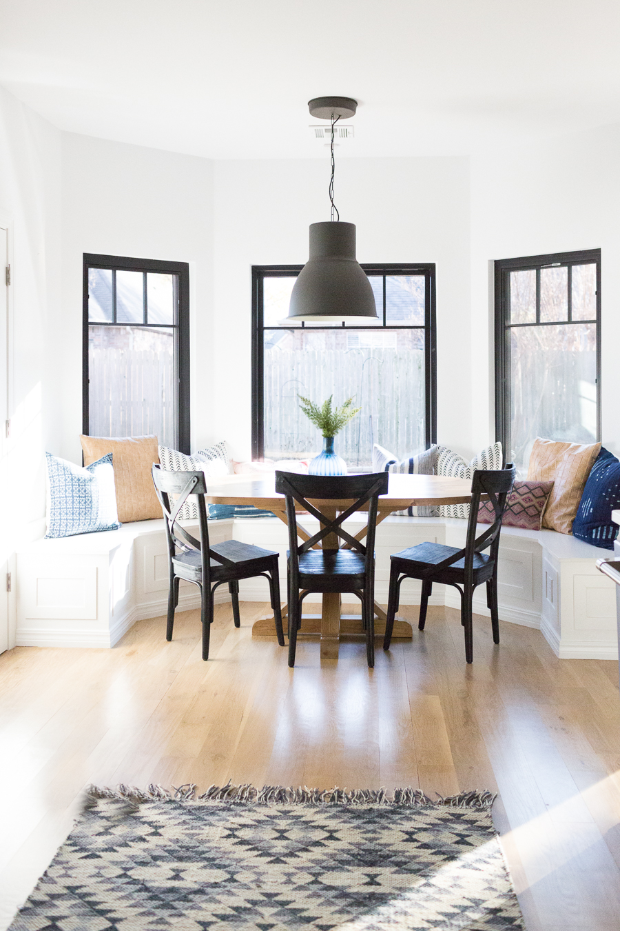 Tulsa Remodel Reveal Modern White Farmhouse black windows and doors black windows and doors built in window seat banquette dining room black pendant lighting-1