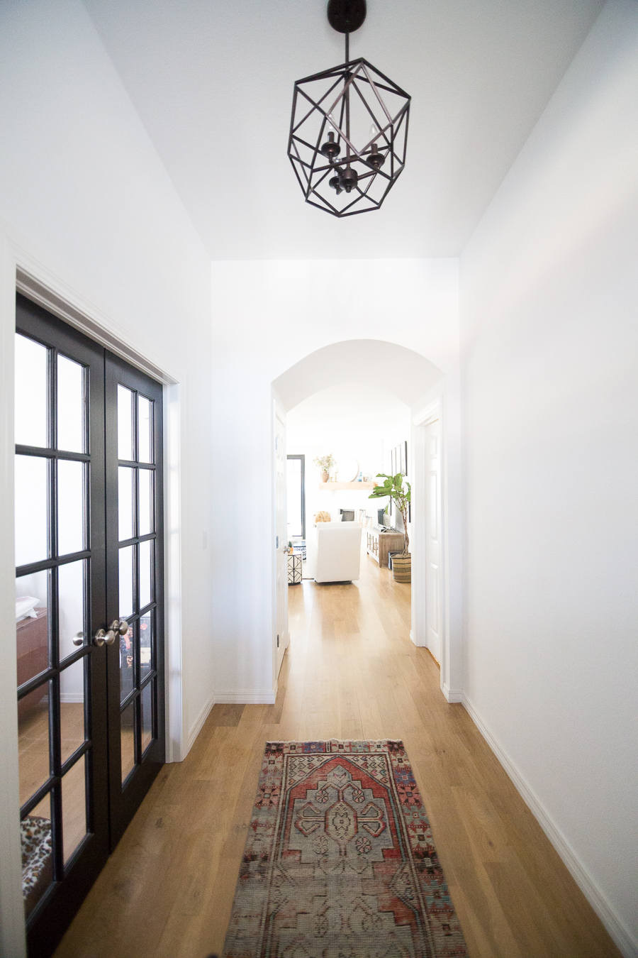 Tulsa Remodel Reveal Modern White Farmhouse black windows and doors kilim rug entryway black hexagon foyer light-1