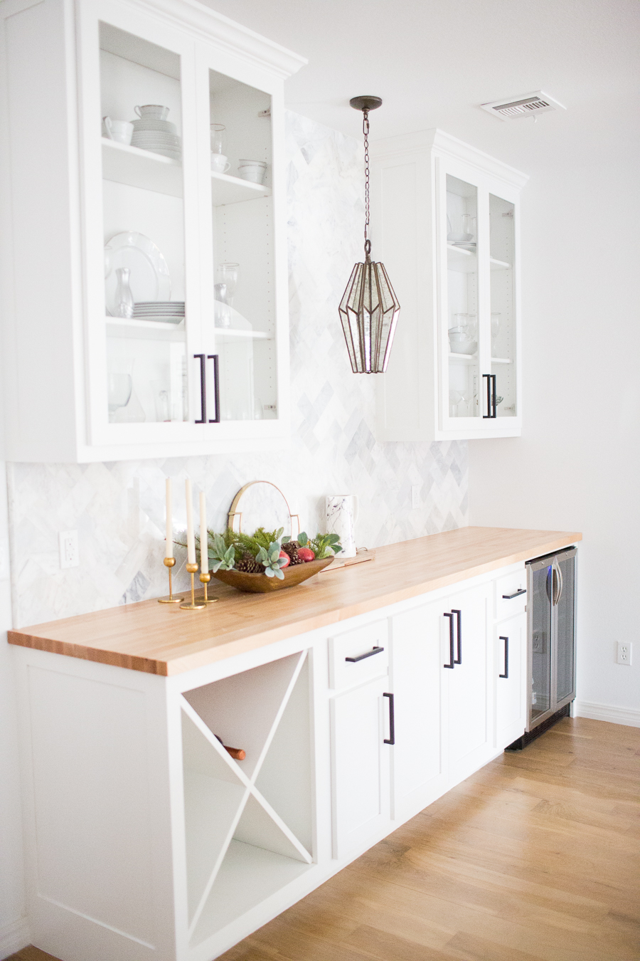 Tulsa Remodel Reveal Modern White Farmhouse black windows and doors marble herringbone backsplash bar butcher block countertop white cabinets black hardware bar faceted pendant lighting-1-3