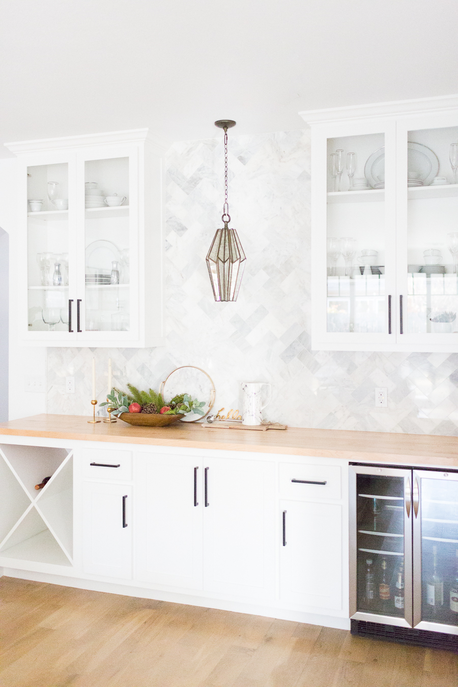 Tulsa Remodel Reveal Modern White Farmhouse black windows and doors marble herringbone backsplash bar butcher block countertop white cabinets black hardware bar faceted pendant lighting-1-4