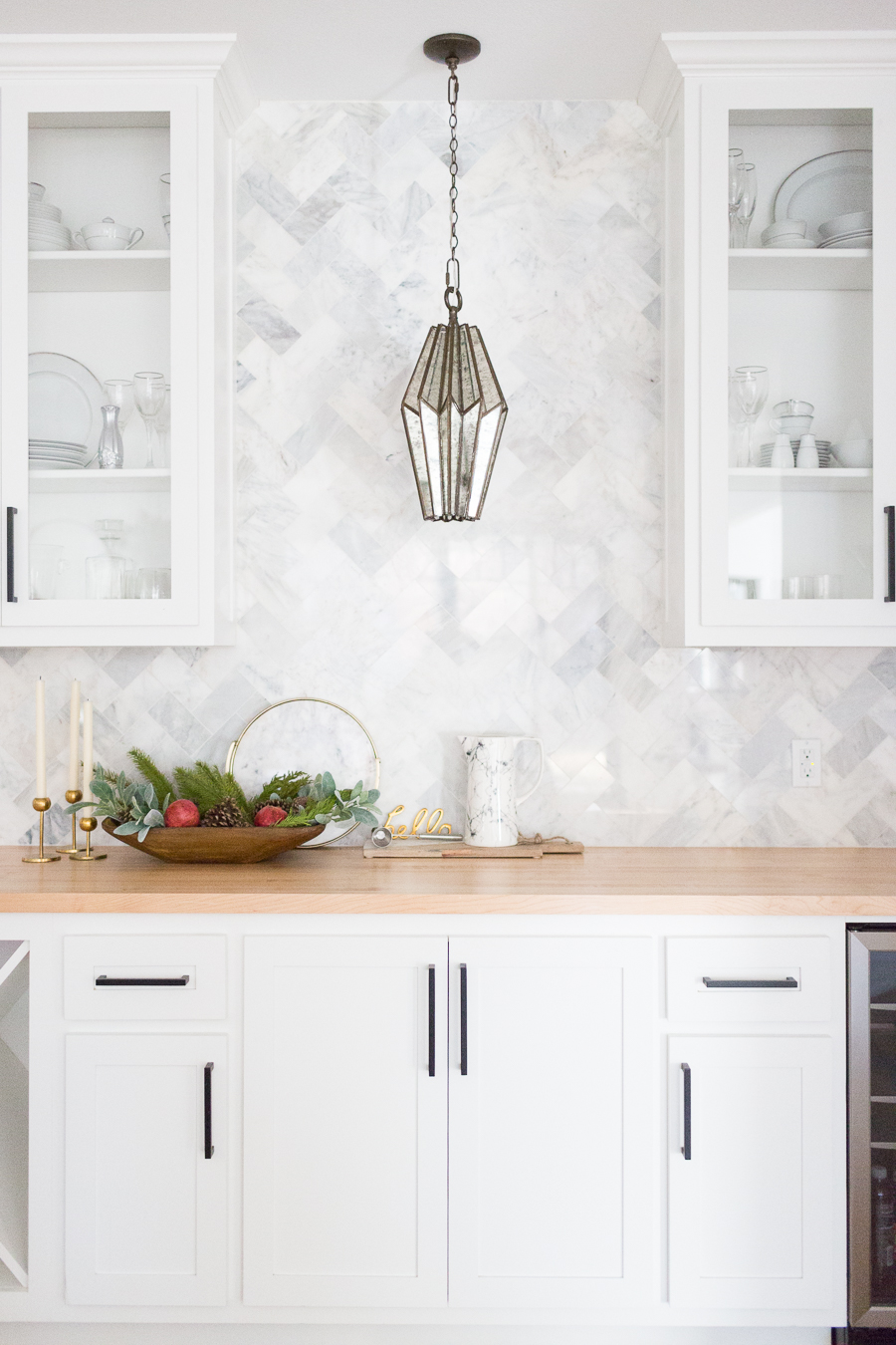 Tulsa Remodel Reveal Modern White Farmhouse black windows and doors marble herringbone backsplash bar butcher block countertop white cabinets black hardware bar faceted pendant lighting-1