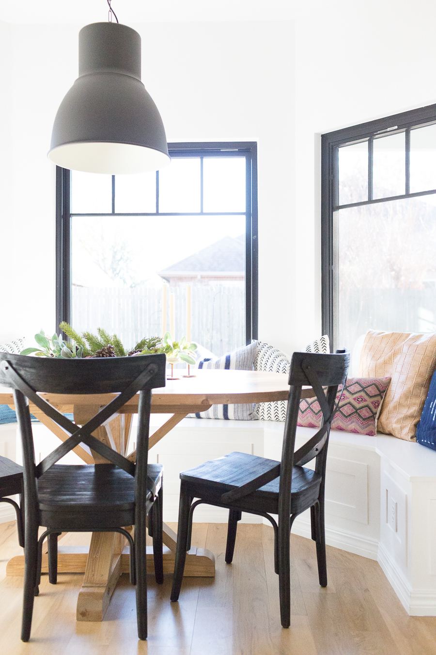 How to Design a Beautiful Kitchen Banquette modern farmhouse black dining room chairs oval wood pedestal table IKEA Hektar black pendant black windows-1-3