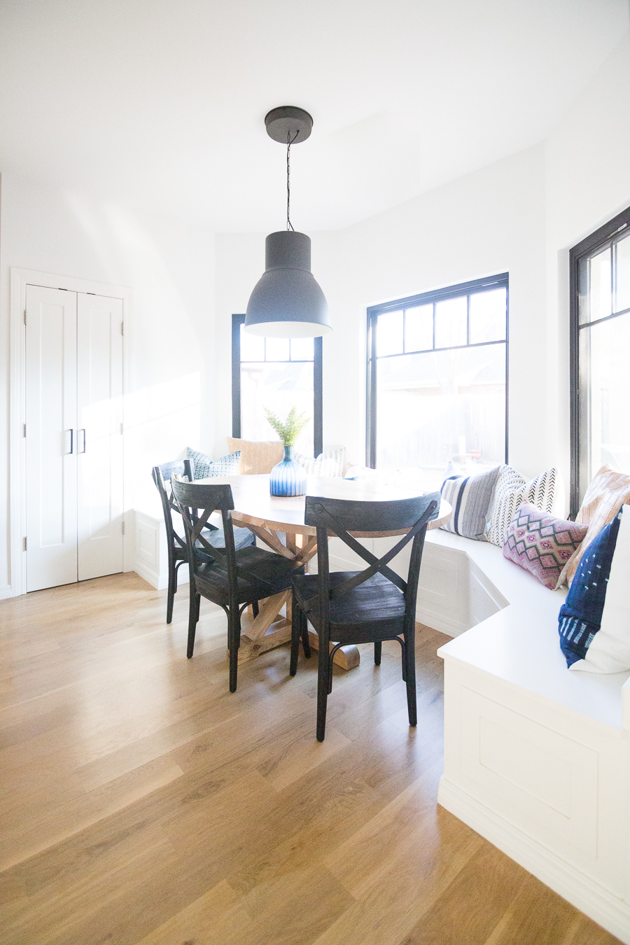 How to Design a Beautiful Kitchen Banquette modern farmhouse black dining room chairs oval wood pedestal table IKEA Hektar black pendant black windows-1-3