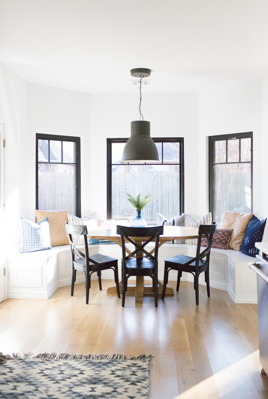 How to Design a Beautiful Kitchen Banquette modern farmhouse black dining room chairs oval wood pedestal table IKEA Hektar black pendant black windows-1-3