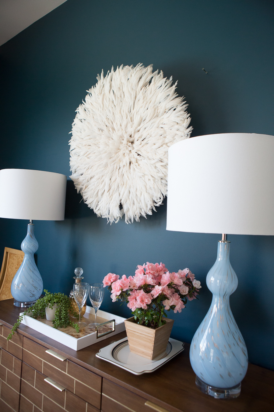 How to Use a Juju Hat in Home Decor dark green painted walls blue cascade lamps dining room credenza styling