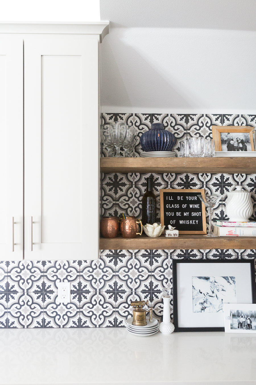 Affordable Ceramic Patterned Tile Backsplash affordable cement tile lookalike black and white patterned tile backsplash open wood shelves kitchen open wood shelves styling ideas how to style open wood shelving blue west elm vase wooden picture frames greige cabinets