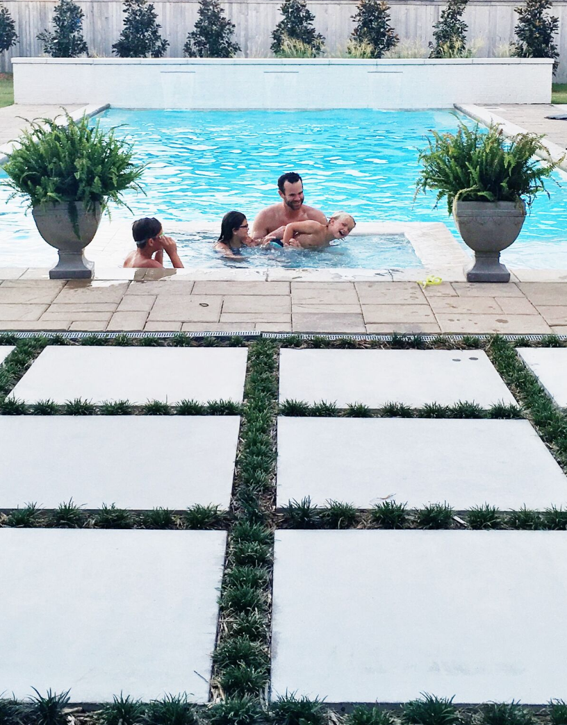 Father's Day Gift Guide concrete pavers with grass growing in between them rectangular pool