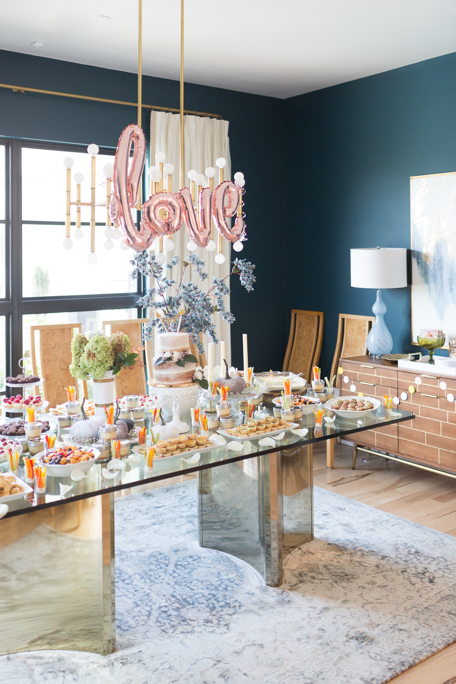 Beautiful Fall Bridal Shower Ideas glass dining room table with gold base set for a fall bridal shower with velvet pumpkins and a two tier cake