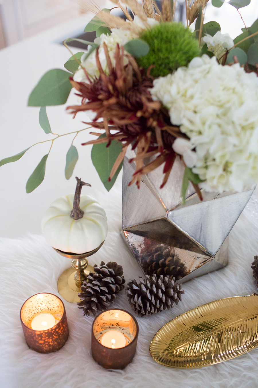 Simple Ways to Decorate for the Holidays from West Elm copper votive candles and pinecones