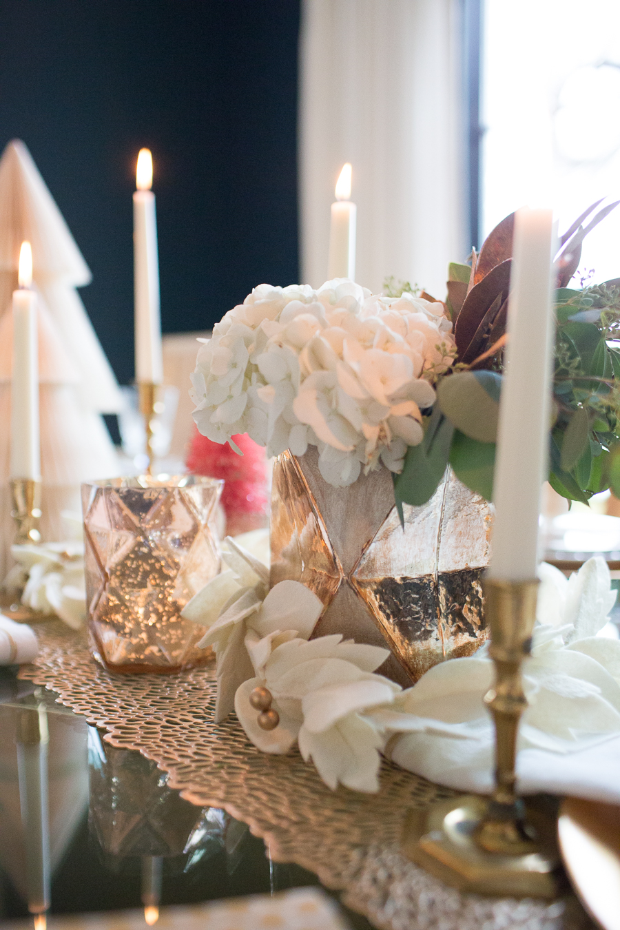 Budget Friendly Holiday Decor from Walmart Christmas tablescape with gold candlesticks and floral arrangements in a hexagon gold vase from West Elm