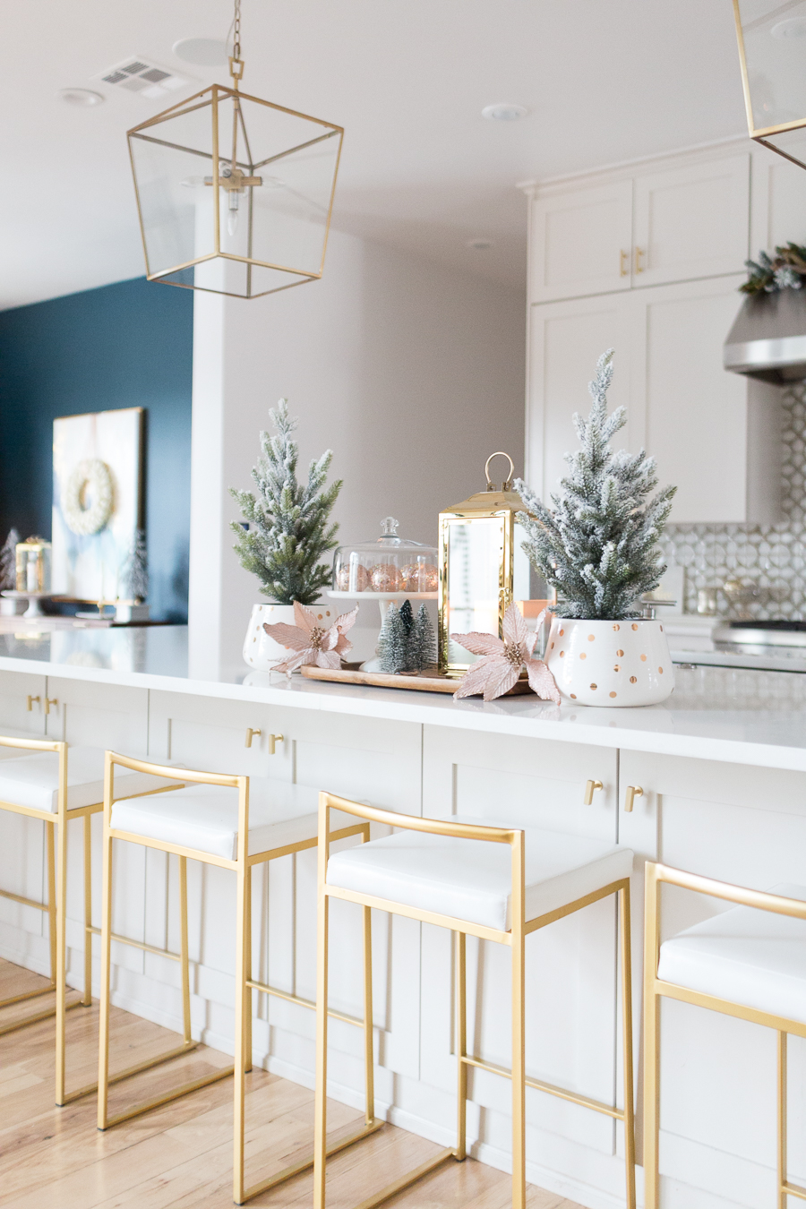 Budget Friendly Holiday Decor from Walmart wood tray with a gold lantern and pioneer woman white cakestand on top of a large quartz waterfall island