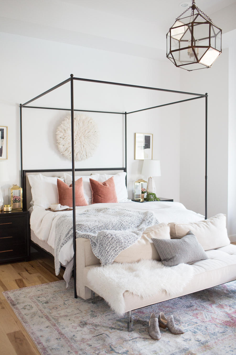 Refresh Your Master Bedroom and Bath with Pottery Barn full view of a white and black bedroom with pastel and gold accents