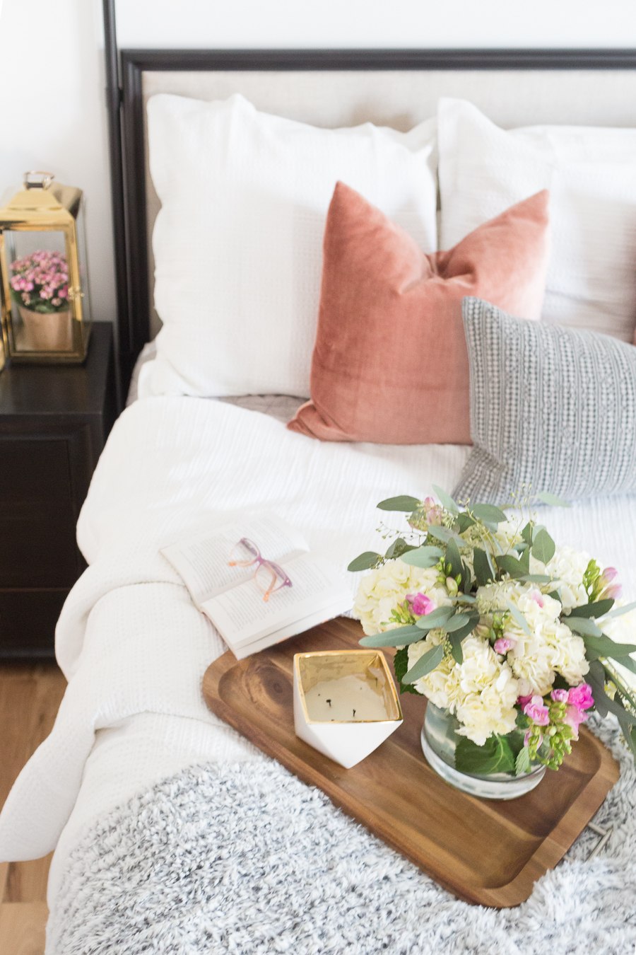 Refresh Your Master Bedroom and Bath with Pottery Barn featured wooden tray with hydrangeas and gold lantern on top of end table