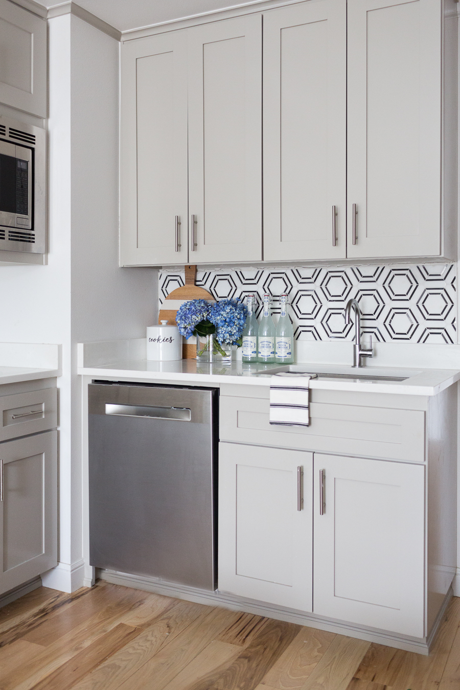 CC and Mike Teen Hangout Room Reveal with Joybird Sectional black and white marble hexagon tile backsplash with gray cabinets and silver hardware