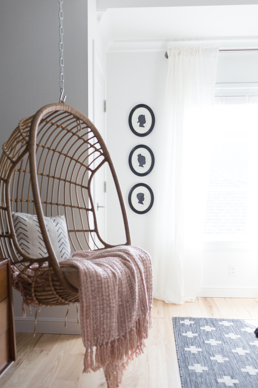 CC and Mike Teen Hangout Room Reveal with Joybird Sectional-3 woven hanging chair and easy $5 DIY silhouette frames on a white painted wall