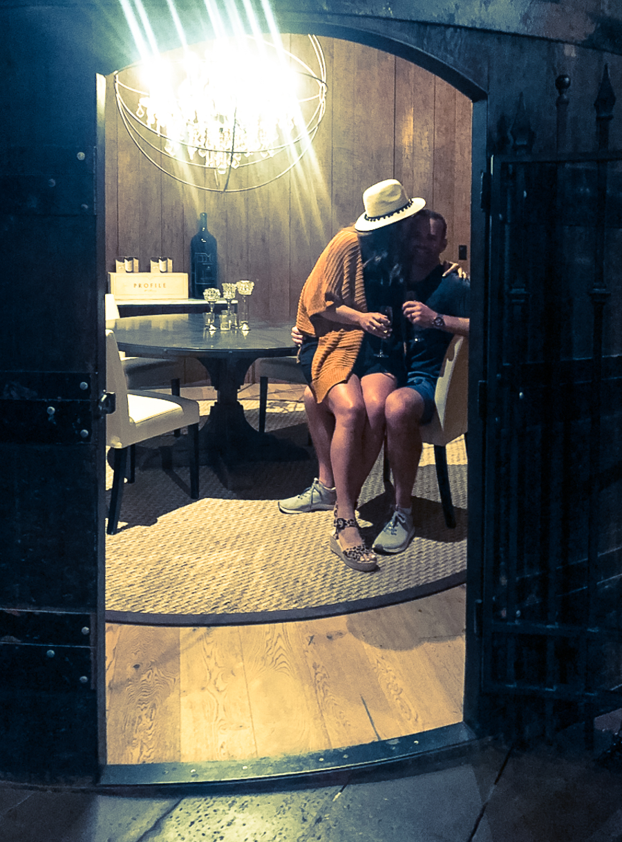 cc and mike in a wine barrel eating dinner 