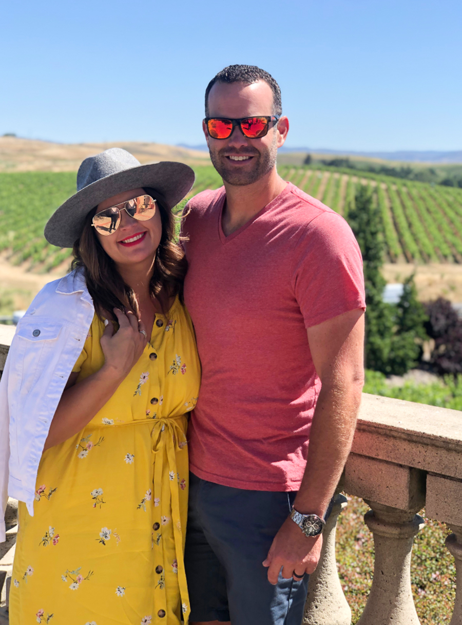 cc and mike in front of vineyards in wine country california