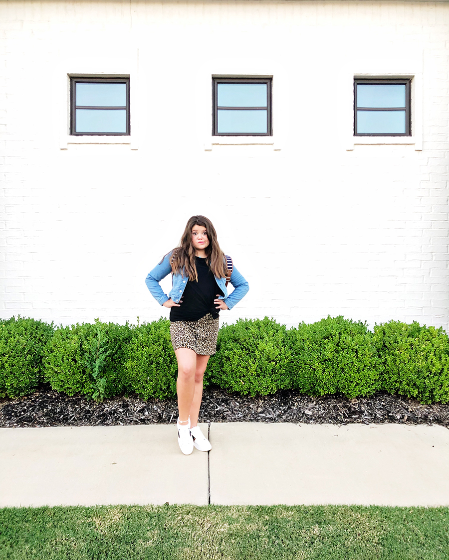 Back-To-School-with-Walmart-Part-Two-mother-and-daughter-in-leopard-shirt-and-skirt-with-jean-jackets-from-Walmart-in-front-of-a-white-brick-wall6