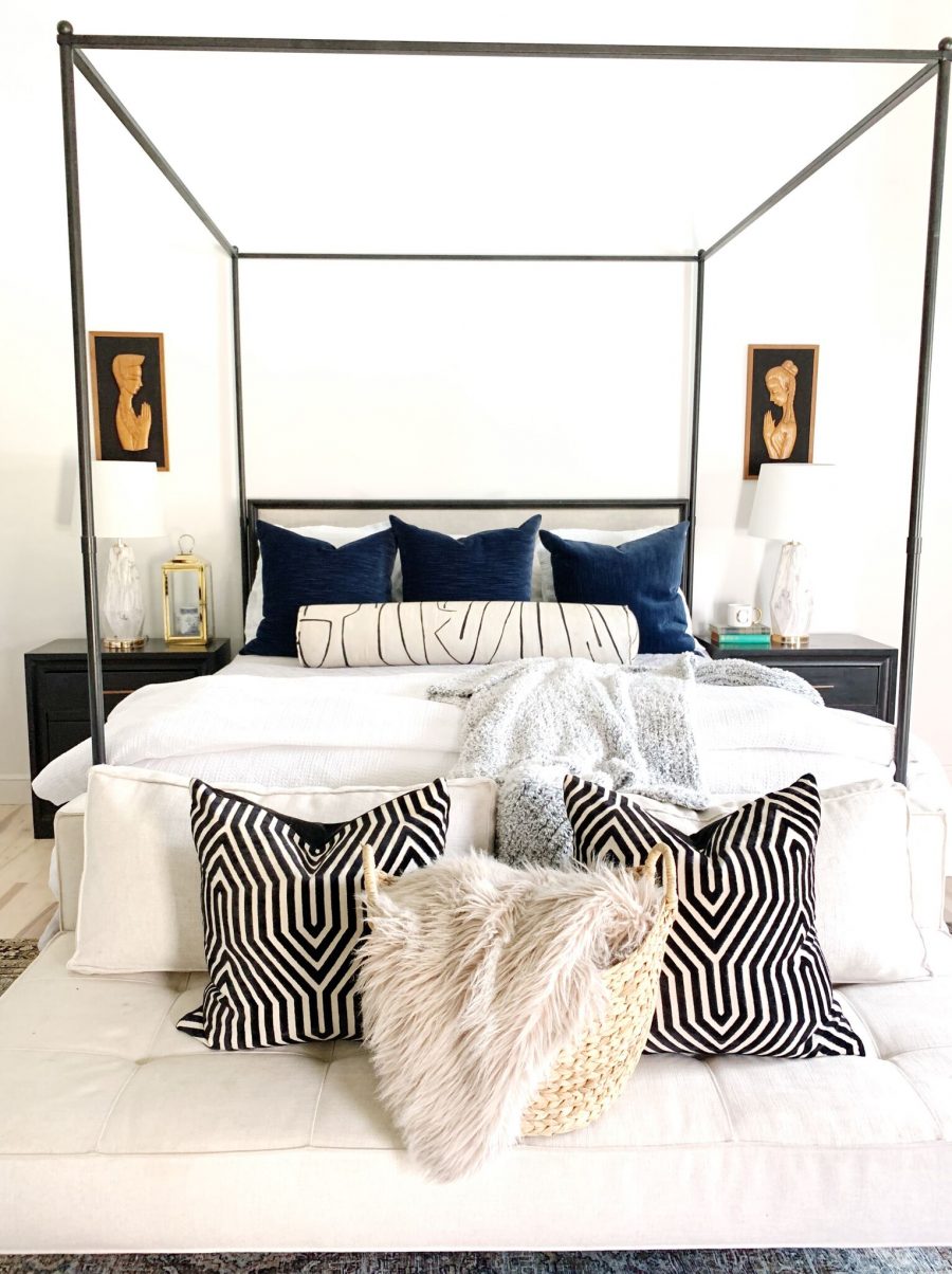 Coastal Master Bedroom Design with Walmart Home Frenchie in a seagrass basket in front of an iron canopy bed