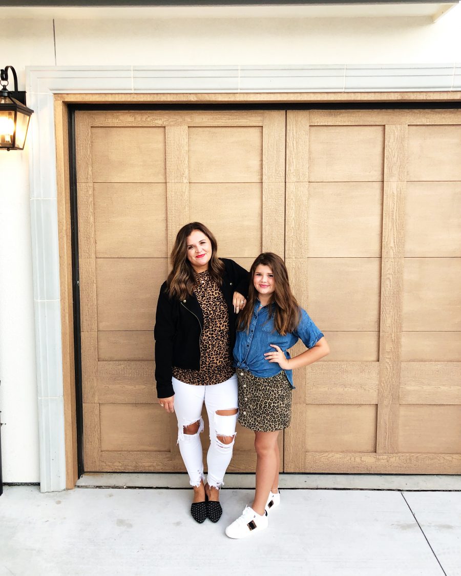 Back-To-School-with-Walmart-Part-Two-mother-and-daughter-in-leopard-shirt-and-skirt-with-jean-jackets-from-Walmart-in-front-of-a-white-brick-wal