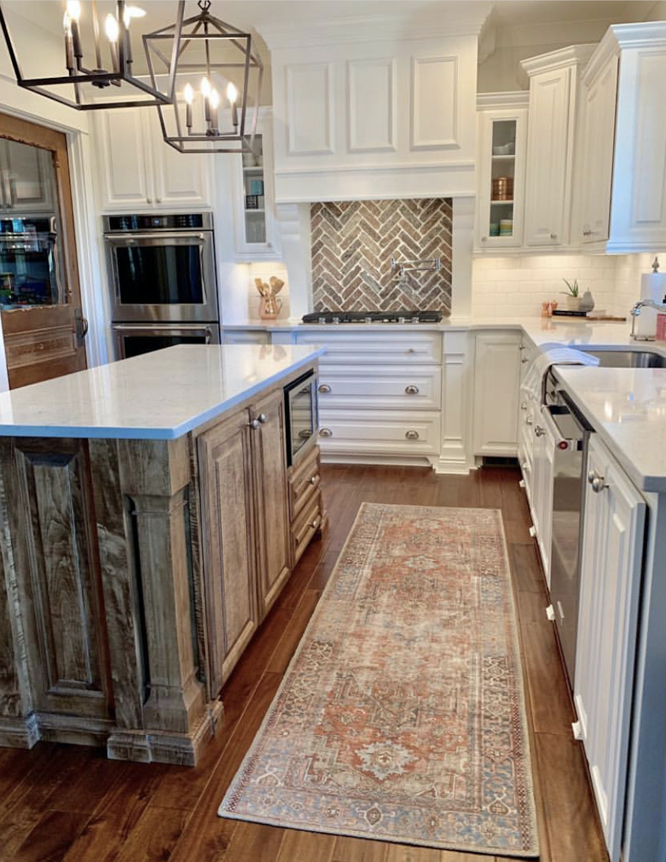 CC and Mike labor day sales terracotta loren rug in a beautiful white kitchen with natural wood island and quartz countertops and white kitchen cabinets with brick backsplash and silver hardware