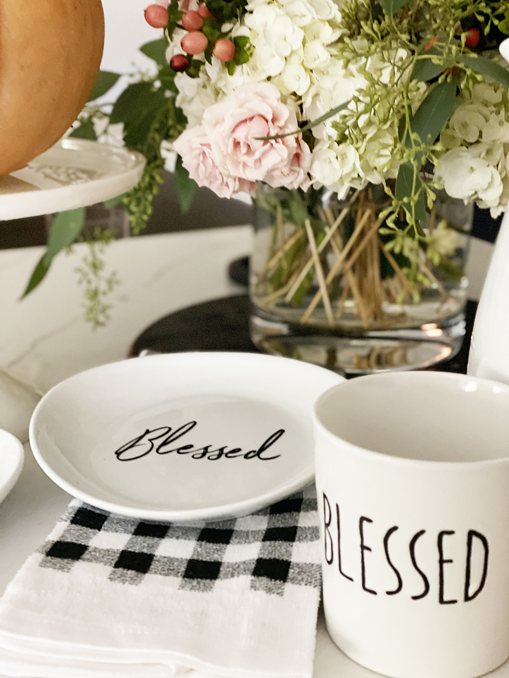 Affordable Fall Front Porch and Tabletop Decor Ideas buffalo plaid dish towel pioneer woman cake stand with pumpkin on top blessed coffee mug and plat