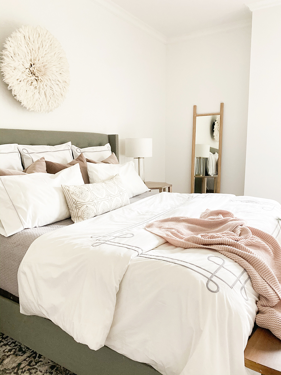 How to Get Your Guest Bedroom Holiday Ready Serena and Lliy Bedding Gray upholstered bed with wood bench and juju hat