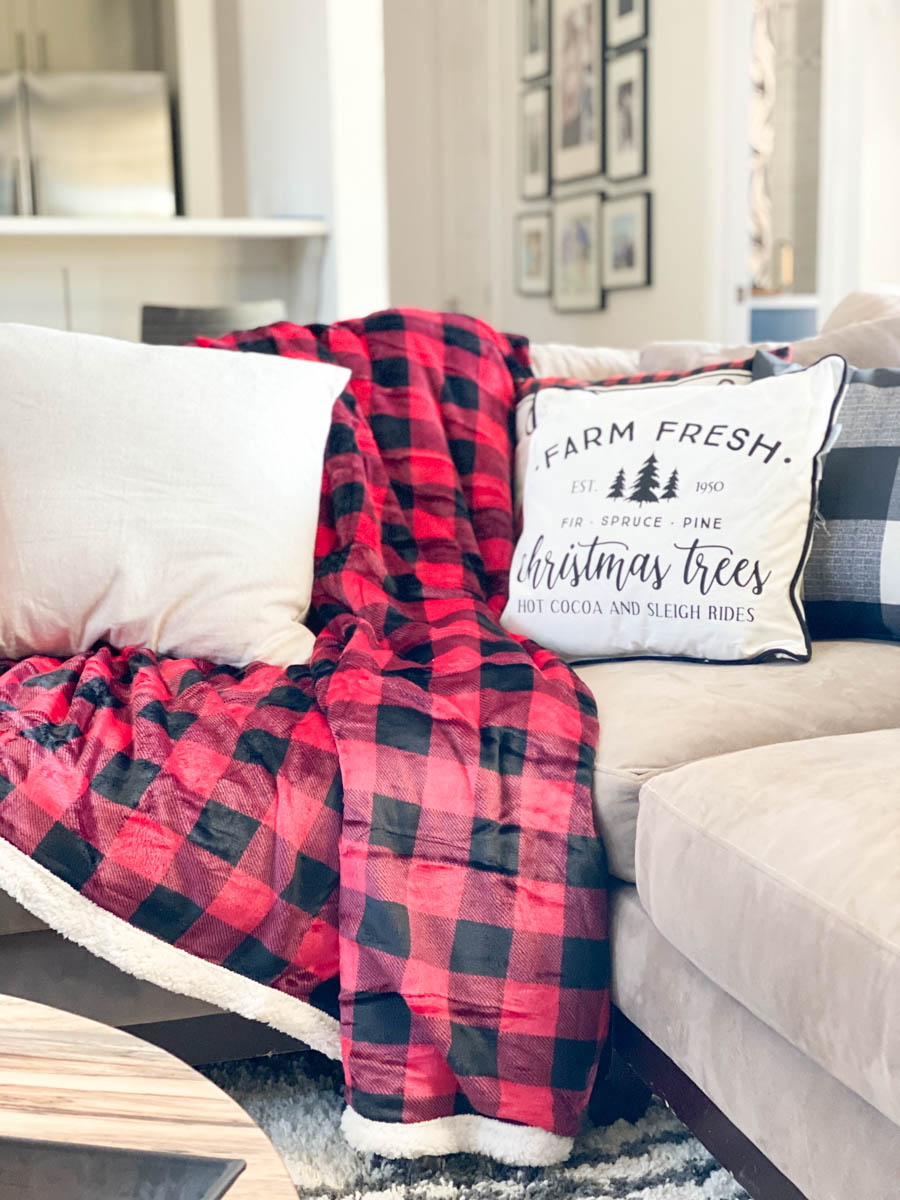 Affordable Buffalo Plaid Holiday Pillows and Decor buffalo plaid pillows and tabletop Christmas trees on a round wood coffee table-2