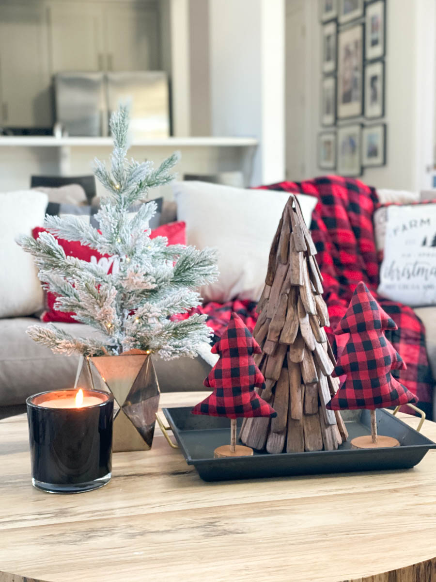 Affordable Buffalo Plaid Holiday Pillows and Decor buffalo plaid pillows and tabletop Christmas trees on a round wood coffee table-2