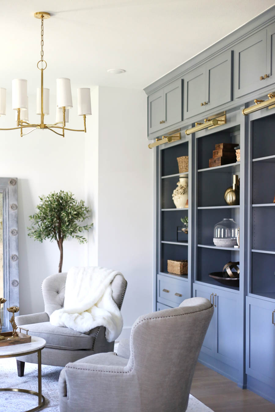 CC and Mike Frisco I Project Reveal-35 gray cabinets with open shelving gold library lighting and chandelier sitting room