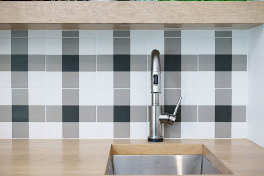 CC and Mike Frisco I Project Reveal black and white buffalo plaid check tile with open wood shelving in a game room bar stainless steel sink with butcher blog countertops