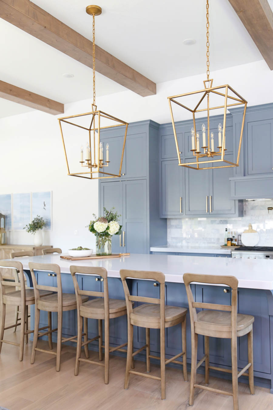 CC and Mike Frisco I Project Reveal-63 gray kitchen island and cabinets with wood bar stools quartz countertops and gold lanterns large kitchen window with gold sconces