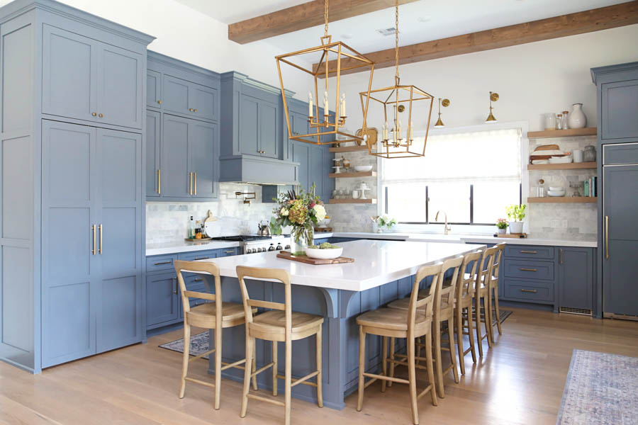 CC and Mike Frisco I Project Reveal-63 gray kitchen island and cabinets with wood bar stools quartz countertops and gold lanterns large kitchen window with gold sconces