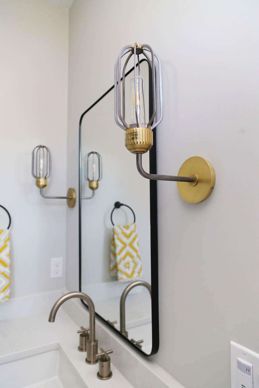 CC and Mike Frisco I Project Reveal black slate tile floors in a boys bathroom design with natural wood cabinets black hardware Franco bathroom mirror and gold and black sconces from CC and Mike THE SHOP 