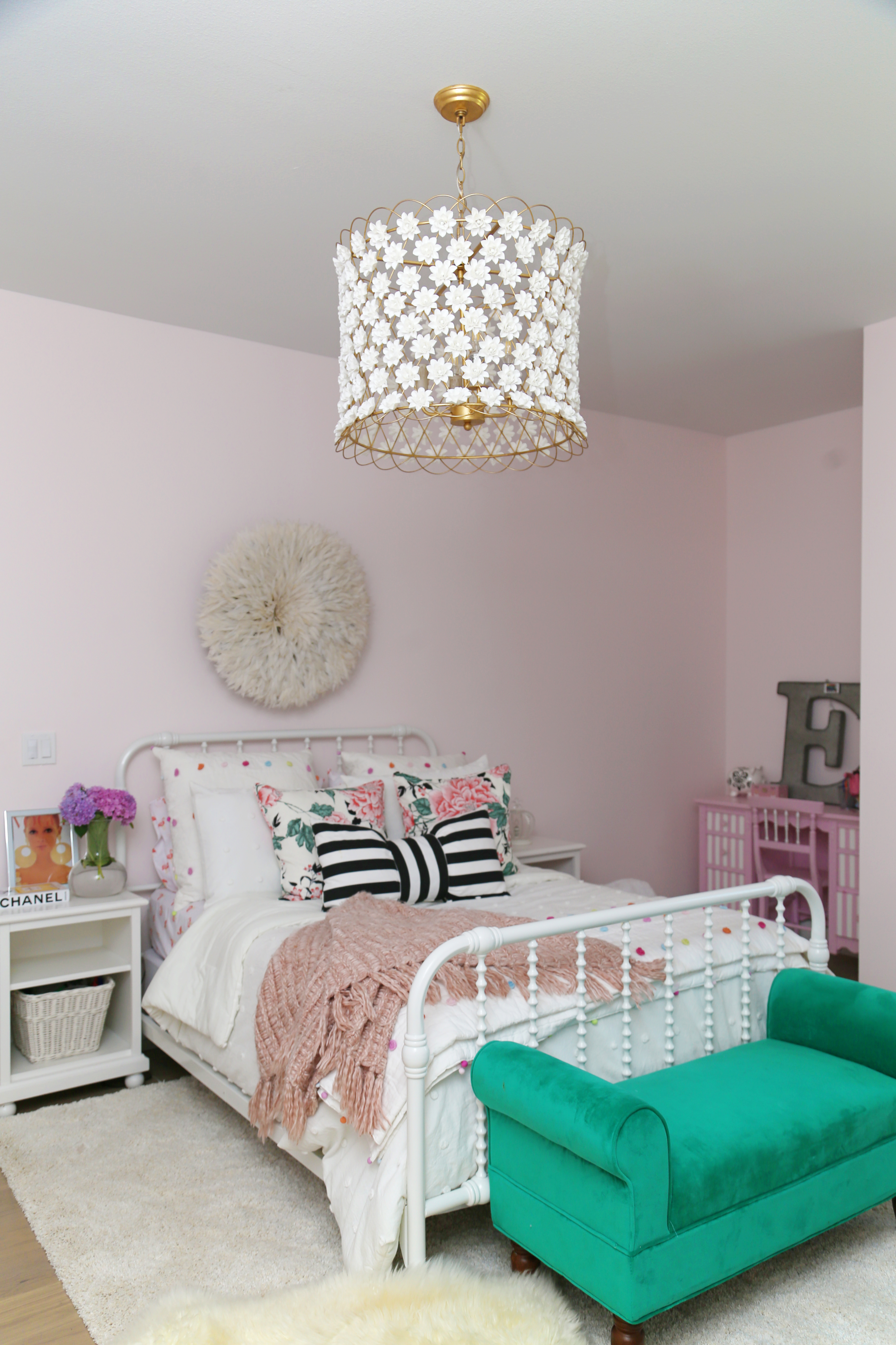 CC and Mike Frisco I Project Reveal ballet pink girls bedroom design with Jenny Lind bed and juju hat hanging above the bed black and white striped bow pillow