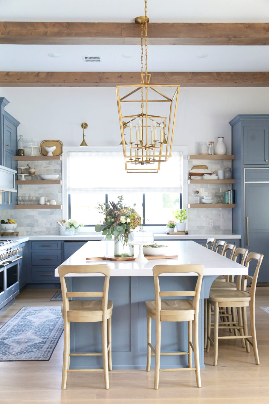 CC and Mike Frisco I Project Reveal-63 gray kitchen island and cabinets with wood bar stools quartz countertops and gold lanterns large kitchen window with gold sconces