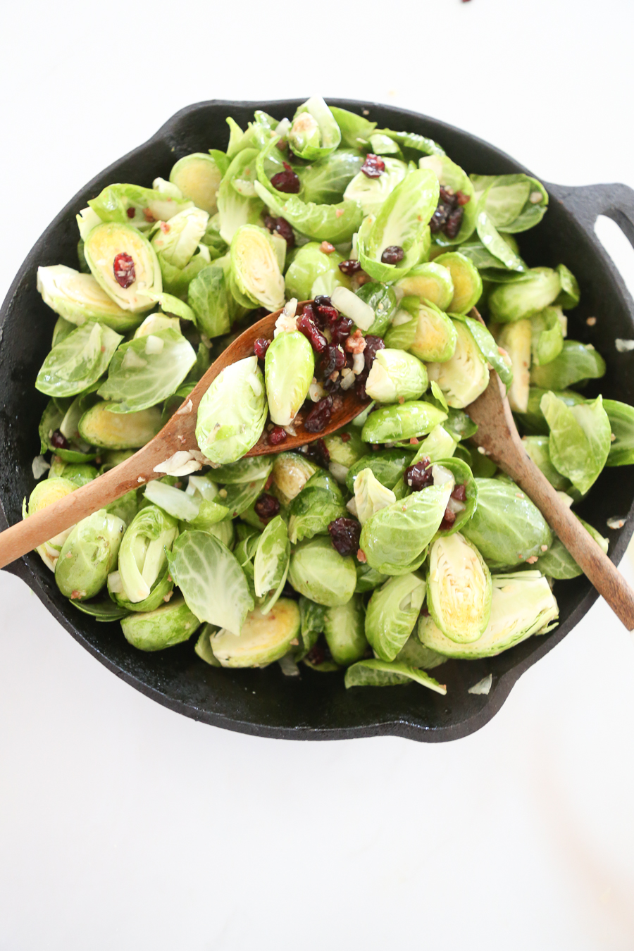 CC AND MIKE'S EXTRA CRISPY CANDIED BRUSSEL SPROUTS RECIPE brussel sprouts with organic maple syrup craisins and real bacon pieces setting on the pioneer woman cutting boards and knives