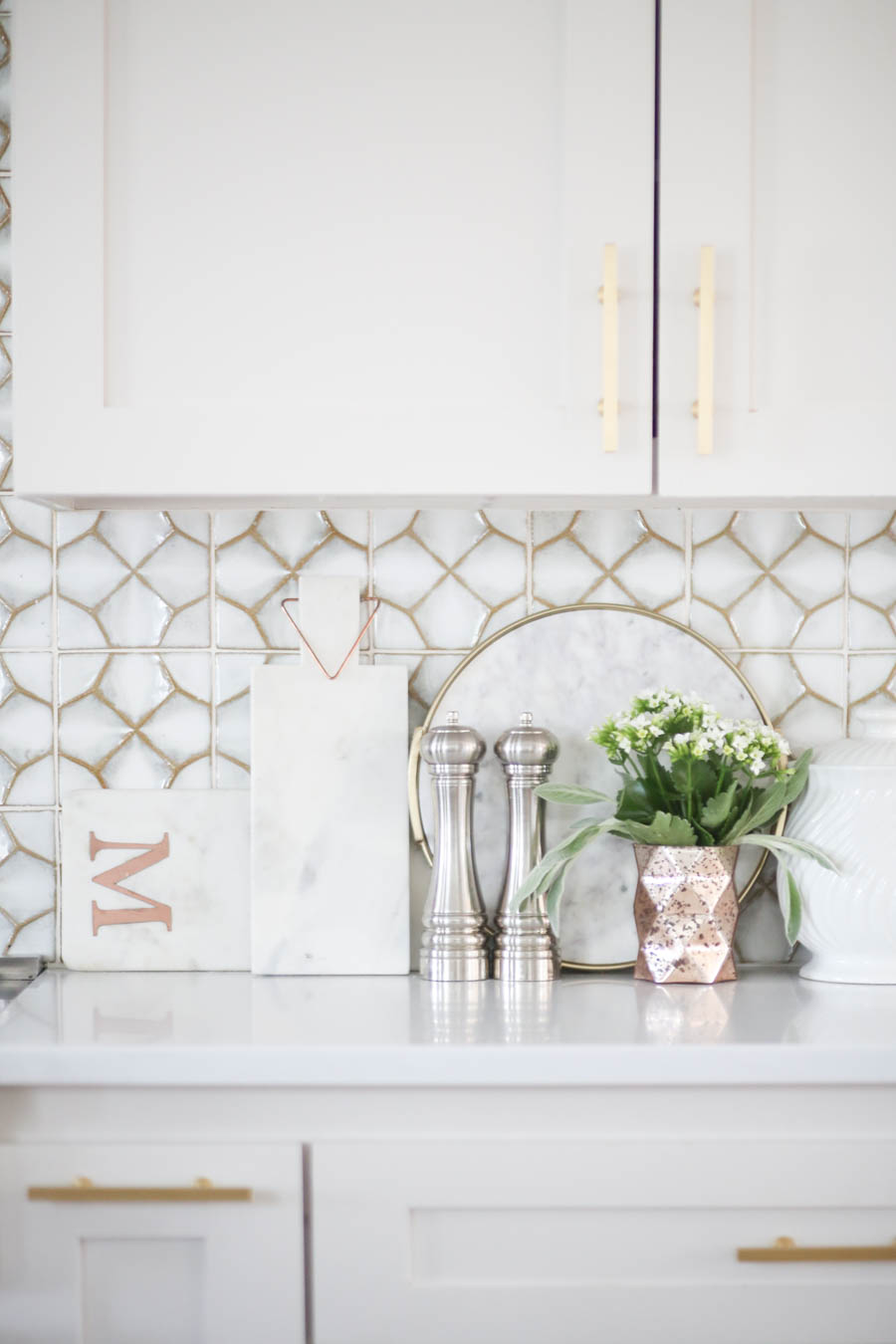 CC and MIke Kitchen Remodel Reveal large natural wood island with quartz countertops and gold bar stools black and gold pendants Ann sacks patterned backsplash gold Brizo faucet large Kallista stainless steel sink open floorpan