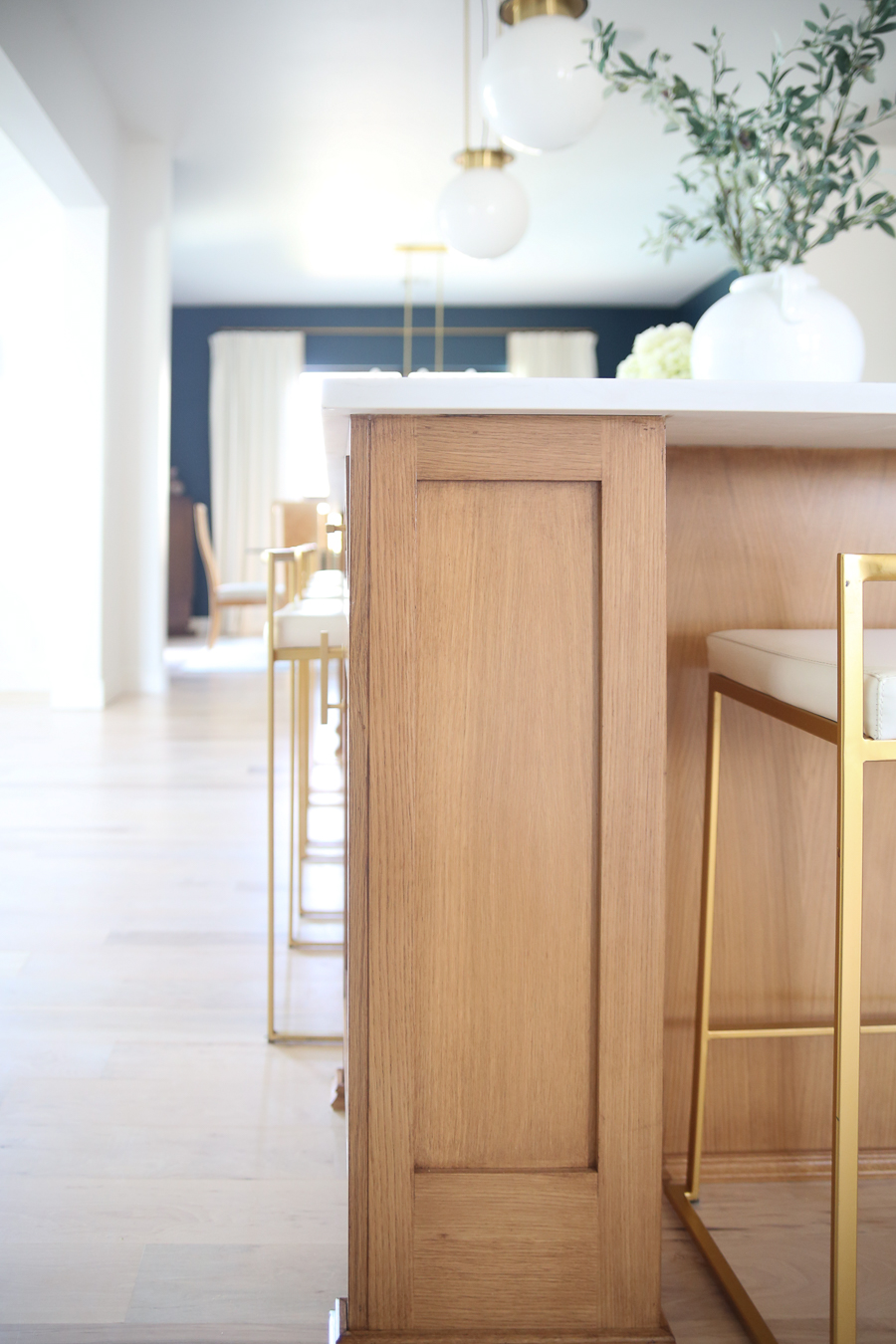 CC and MIke Kitchen Remodel Reveal large natural wood island with quartz countertops and gold bar stools black and gold pendants Ann sacks patterned backsplash gold Brizo faucet large Kallista stainless steel sink open floorpan