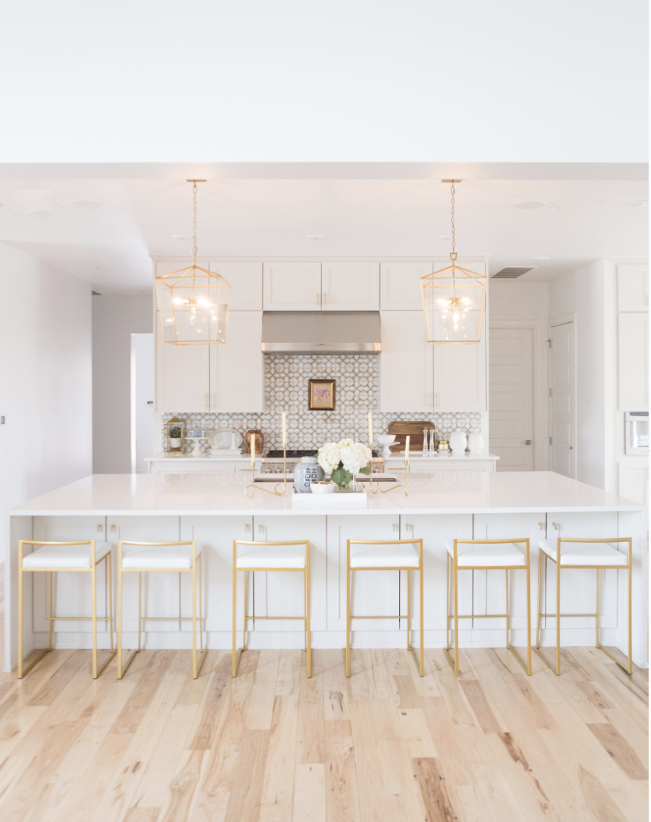 CC and MIke Kitchen Remodel Reveal large natural wood island with quartz countertops and gold bar stools black and gold pendants Ann sacks patterned backsplash gold Brizo faucet large Kallista stainless steel sink open floorpan