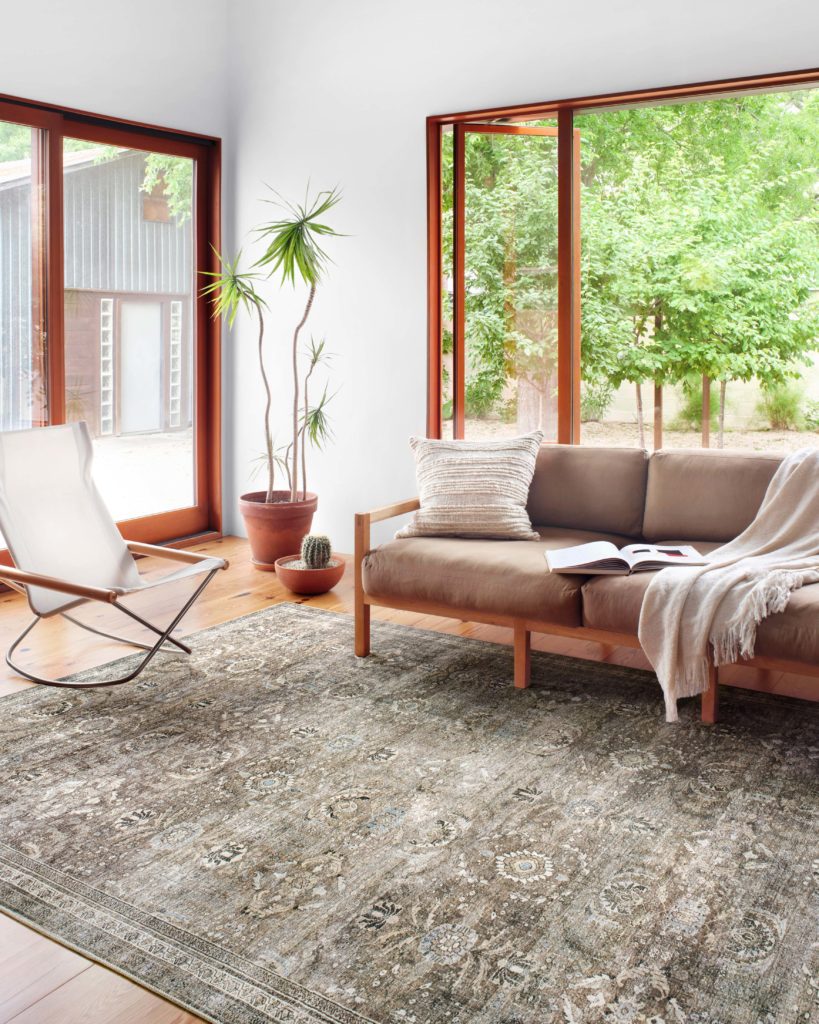 Spacious minimalist living room with moss green area rug: Layla in Antique Moss